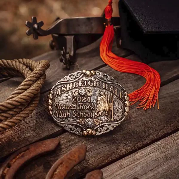 A custom rodeo belt buckle for Round Rock High School featuring a pole bending cowgirl figure